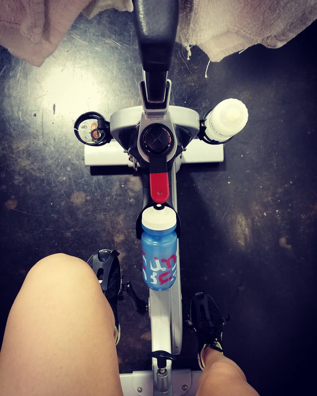 Person on an indoor cycling bike with a nuun water bottle