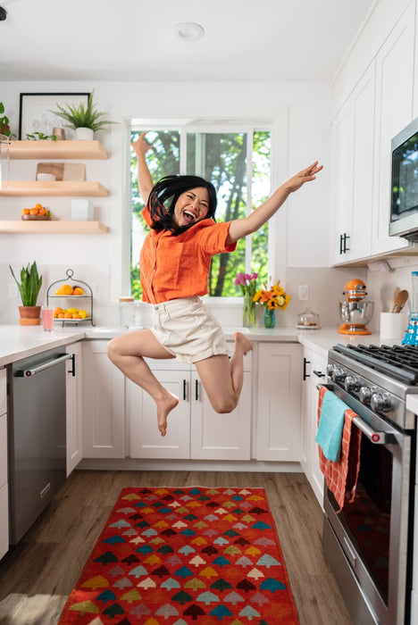 Woman jumping with Nuun Sport in background