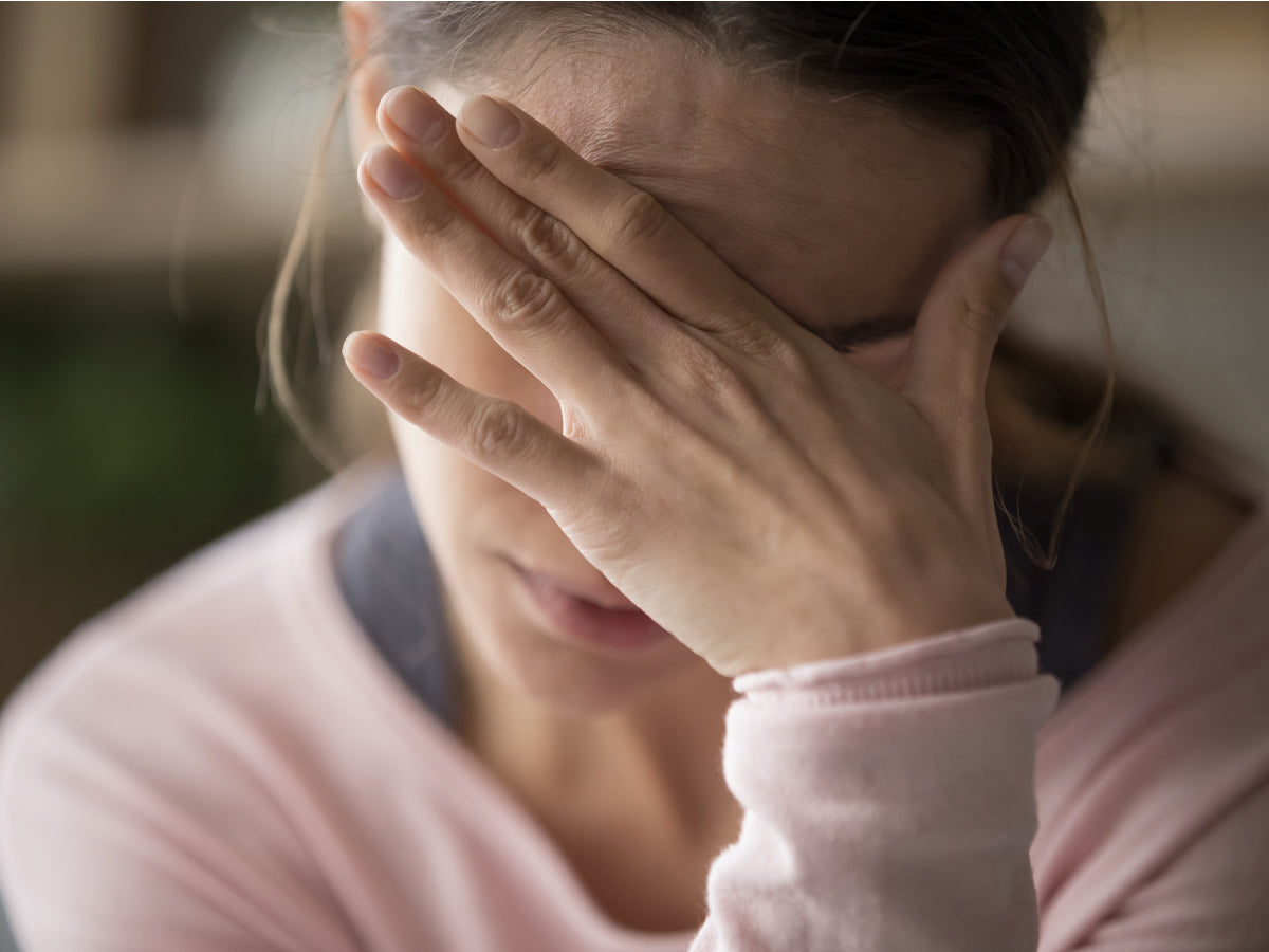 Sad tired woman touching face
