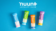 4 tubes of Nuun laying flat against a blue background.