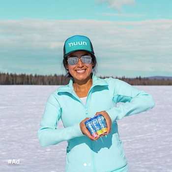 Woman holding three flavors of Nuun Sport Tablets