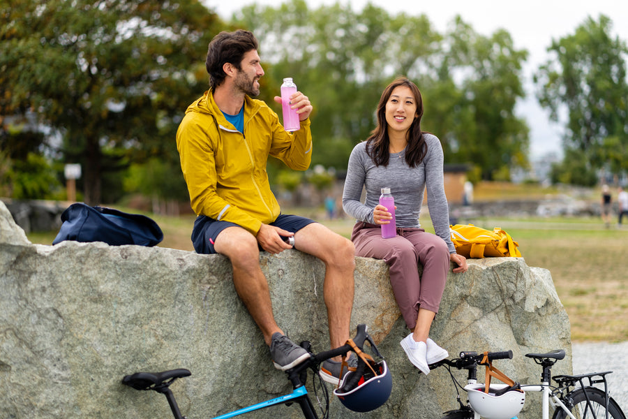 two people drinking Nuun Sport while on a bike ride