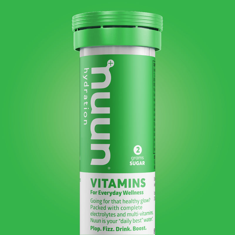 A tube of Nuun Vitamins on a green background.